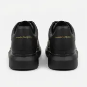 Alexander McQueen Oversized Black Sneakers Back View Pair Gold Logo - SHUZAR Egypt