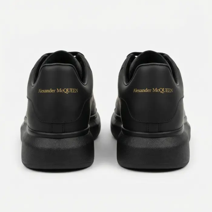 Alexander McQueen Oversized Black Sneakers Back View Pair Gold Logo - SHUZAR Egypt