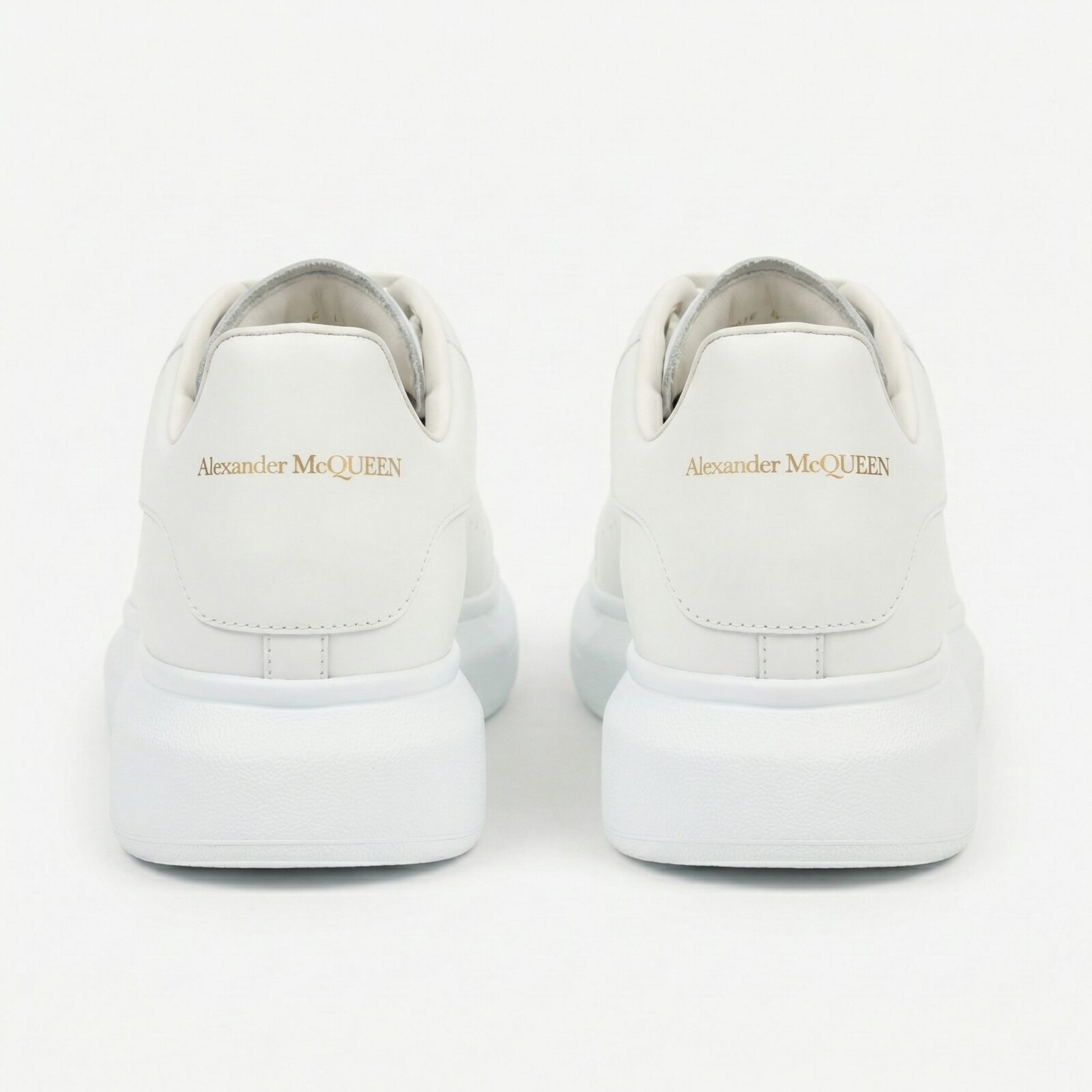 Alexander McQueen Oversized White sneakers back view showing gold logo on heel – SHUZAR Egypt