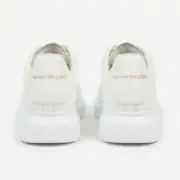 Alexander McQueen Oversized White sneakers back view showing gold logo on heel – SHUZAR Egypt