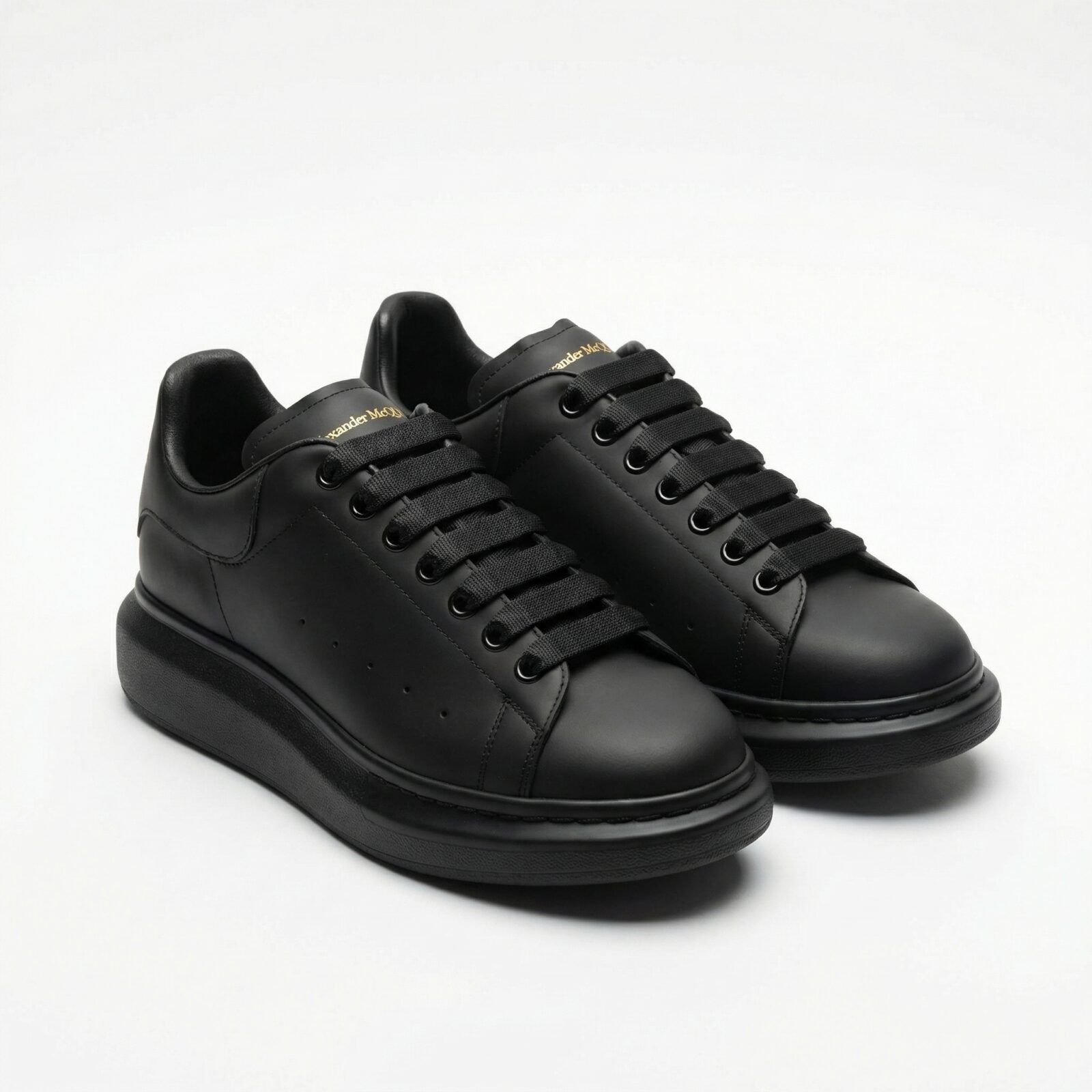 Alexander McQueen Oversized Black Sneakers Front View Pair - SHUZAR Egypt