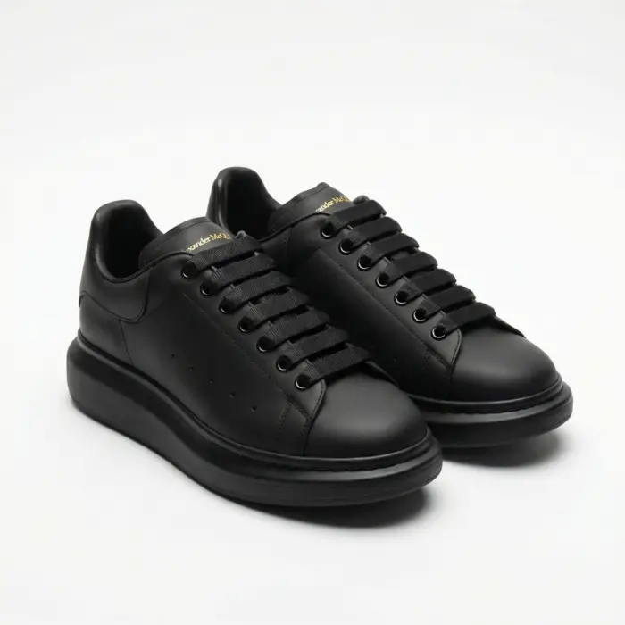 Alexander McQueen Oversized Black Sneakers Front View Pair - SHUZAR Egypt